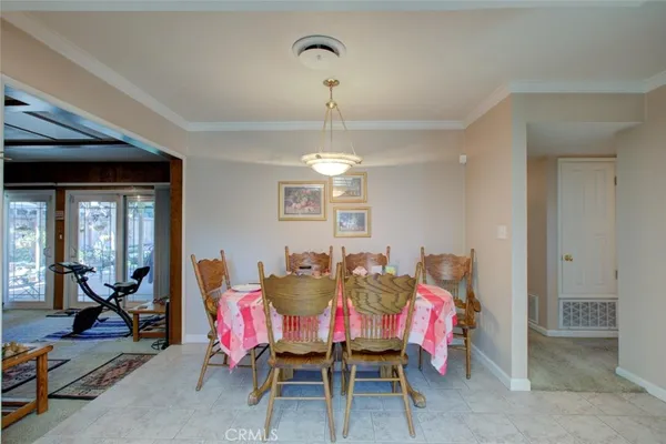 a view of a dining room with furniture and chandelier