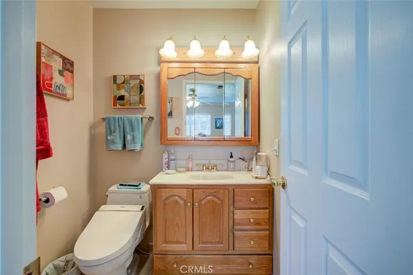 a bathroom with a toilet sink and mirror
