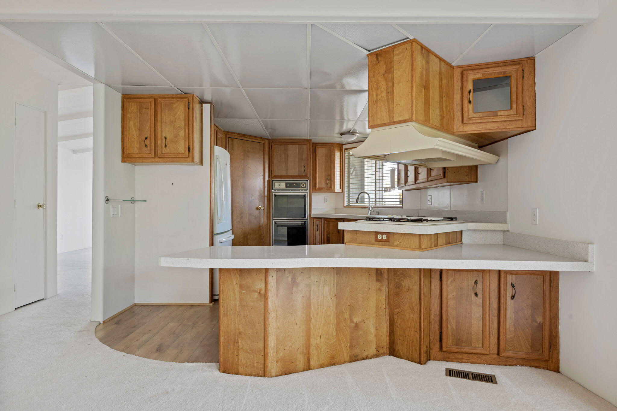 340 Old Mill Road, Unit 107 Santa Barbara, CA 93110 - Photo 11 of 33 a kitchen with stainless steel appliances granite countertop a sink a stove and a wooden cabinets