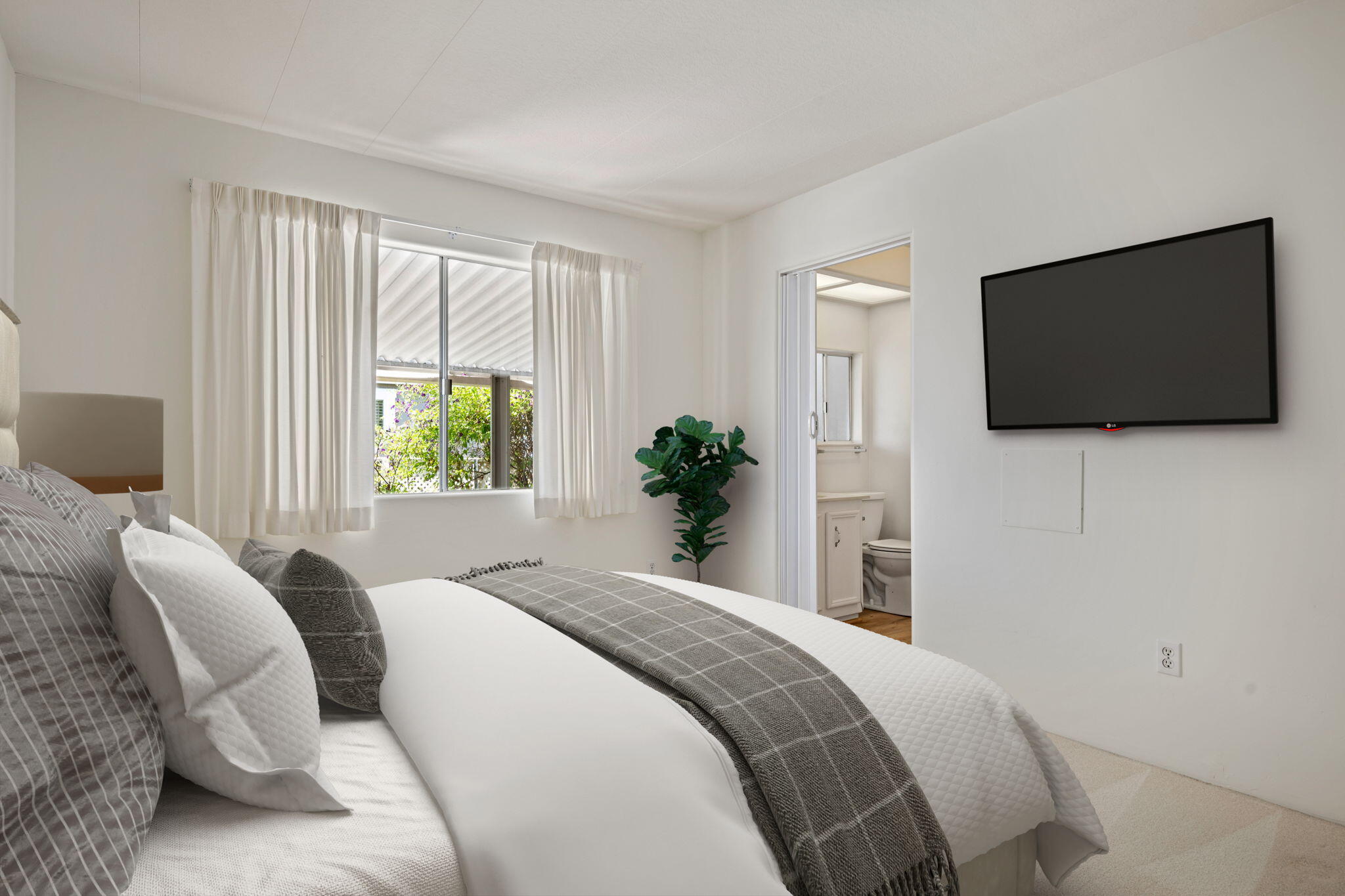 340 Old Mill Road, Unit 107 Santa Barbara, CA 93110 - Photo 16 of 33 a bedroom with a bed and a flat screen tv