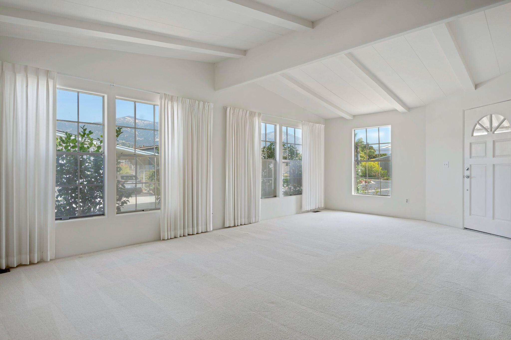 340 Old Mill Road, Unit 107 Santa Barbara, CA 93110 - Photo 4 of 33 a view of an empty room with windows and a balcony