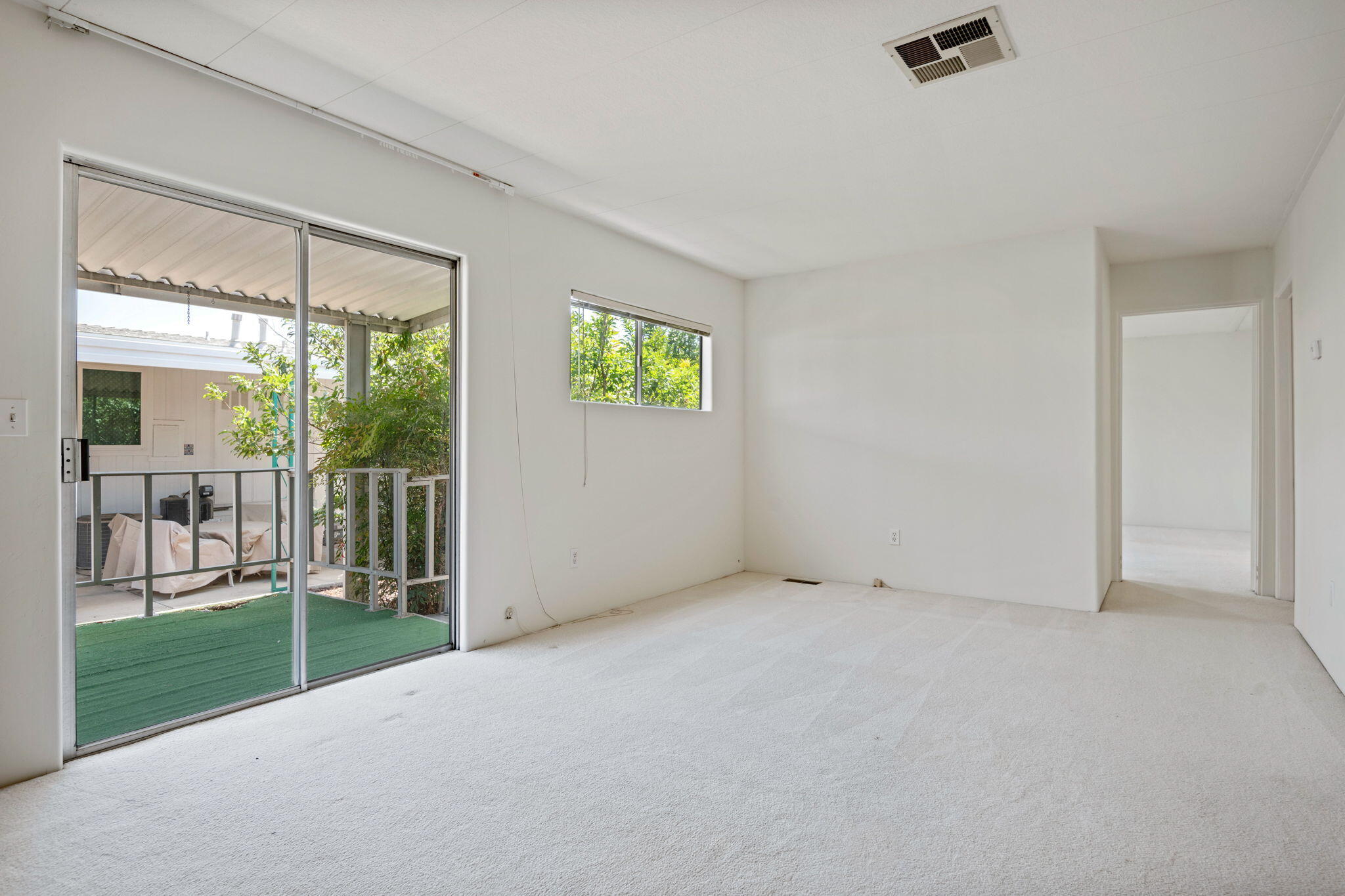 340 Old Mill Road, Unit 107 Santa Barbara, CA 93110 - Photo 8 of 33 en empty room with sliding door and wooden floor