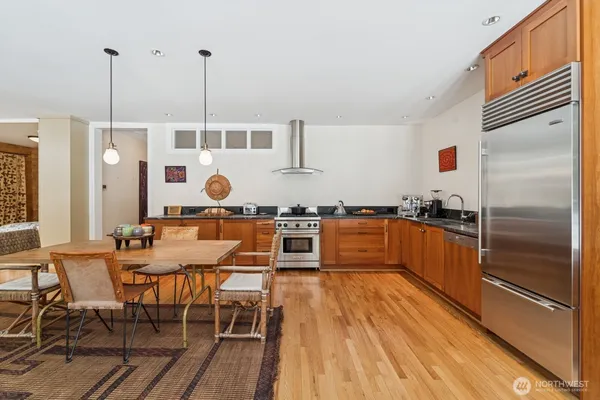 a kitchen with stainless steel appliances granite countertop a stove a sink and a refrigerator