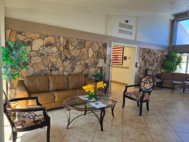 a living room with furniture and flowers