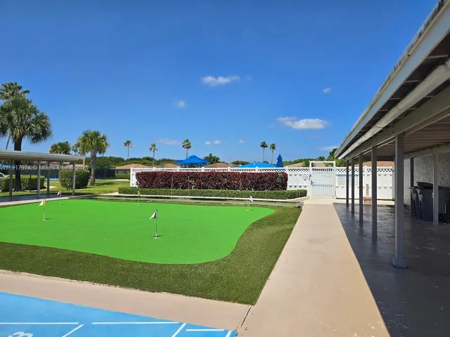 a view of a house with backyard and porch