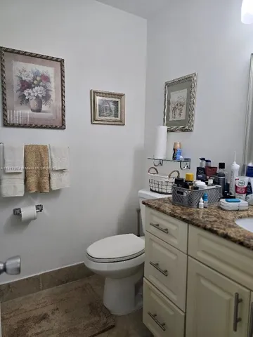 a bathroom with a toilet sink and mirror