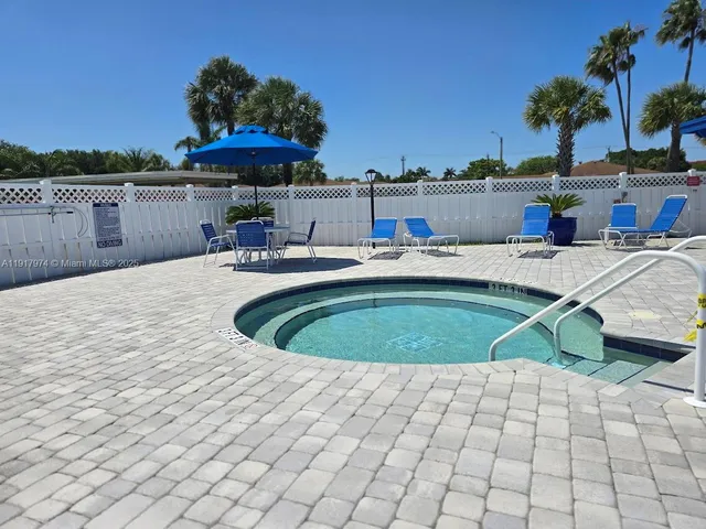 a view of a swimming pool with a lounge chairs