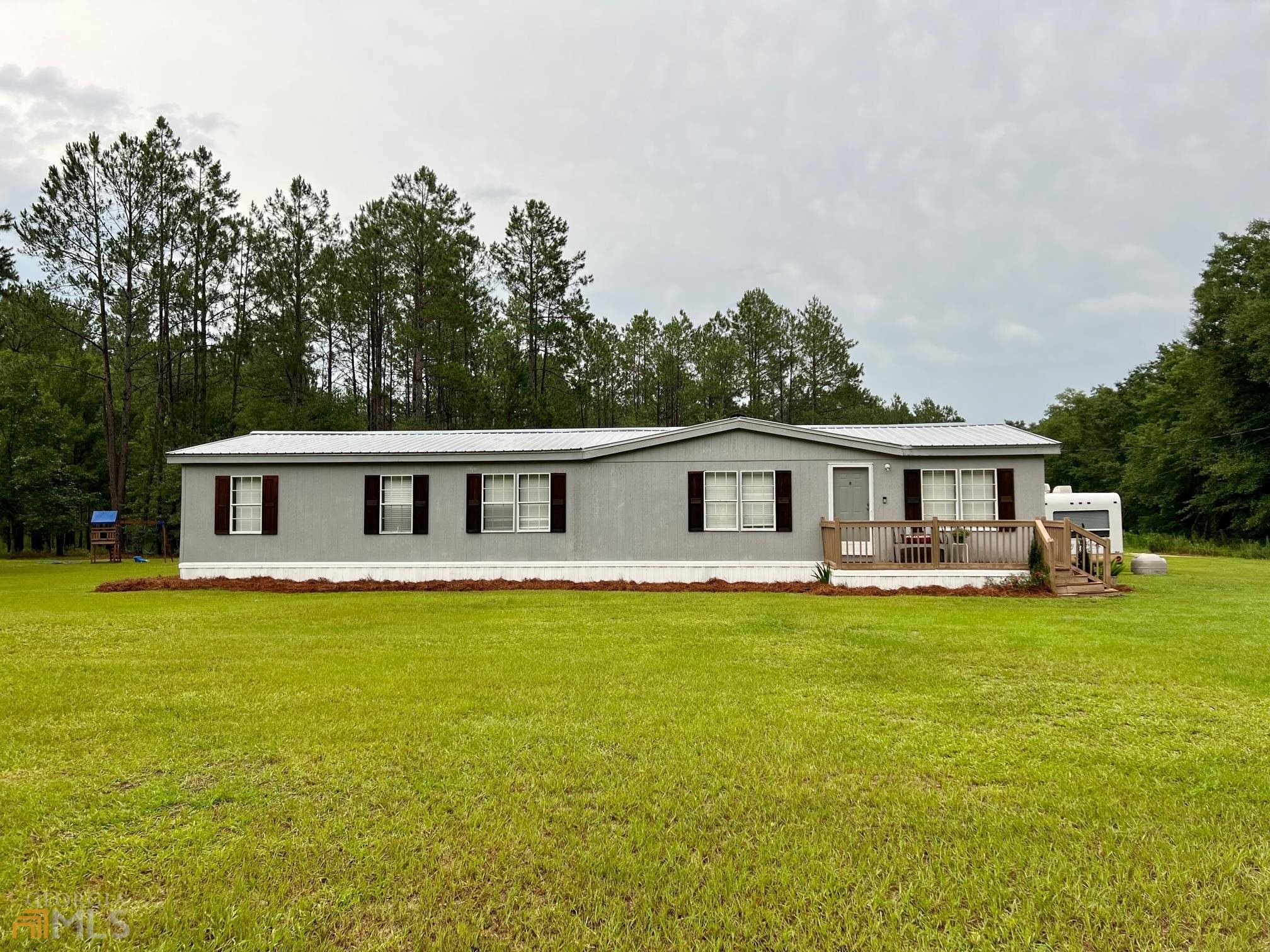 12662 Union Road Metter, GA 30439 - Photo 1 of 1 a house that has swimming pool in front of it