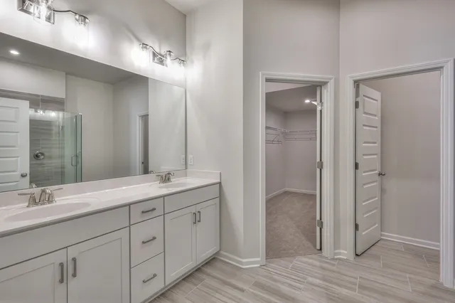 a bathroom with a double vanity sink and mirror