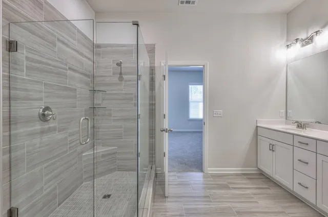 a bathroom with a shower and a sink