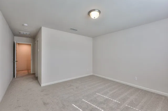 an empty room with a empty space and windows