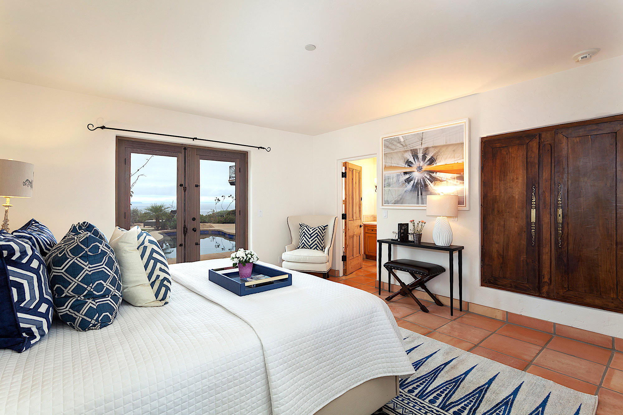 4045 Bajada Lane Santa Barbara, CA 93110 - Photo 21 of 32 a bedroom with a bed a large window with table and chair