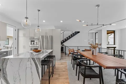 a dining room with furniture and wooden floor