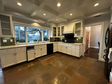 a dining room with furniture a chandelier and wooden floor
