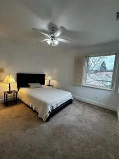 a bedroom with a bed and window