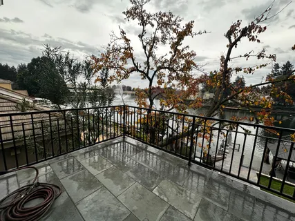 a spacious bedroom with a bed and a large window