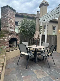 a view of a patio with table and chairs and potted plants
