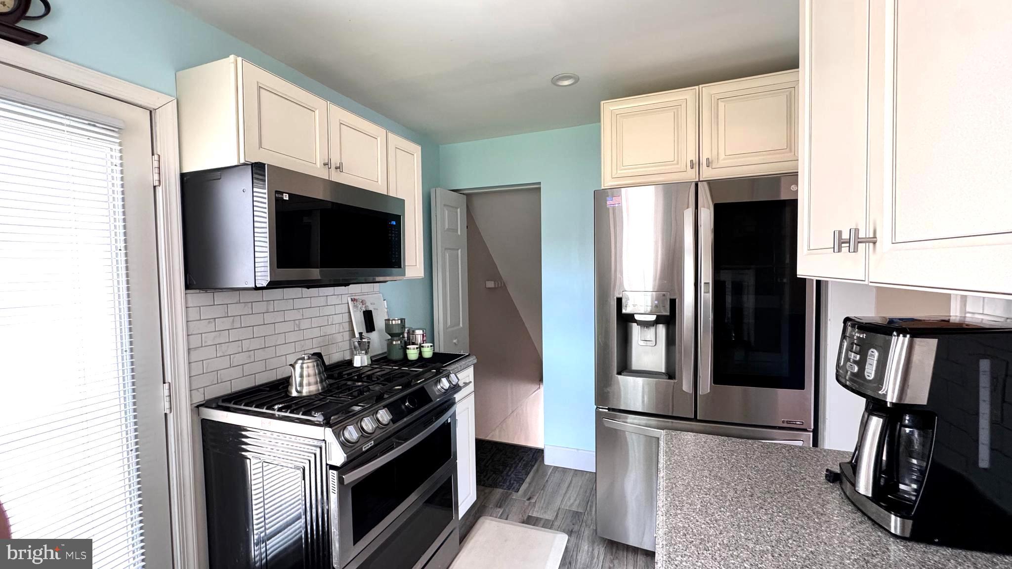 1029 Lamb Road Secane, PA 19018 - Photo 20 of 78 a kitchen with stainless steel appliances a stove a microwave and refrigerator