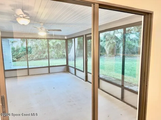 a view of an empty room with windows and balcony