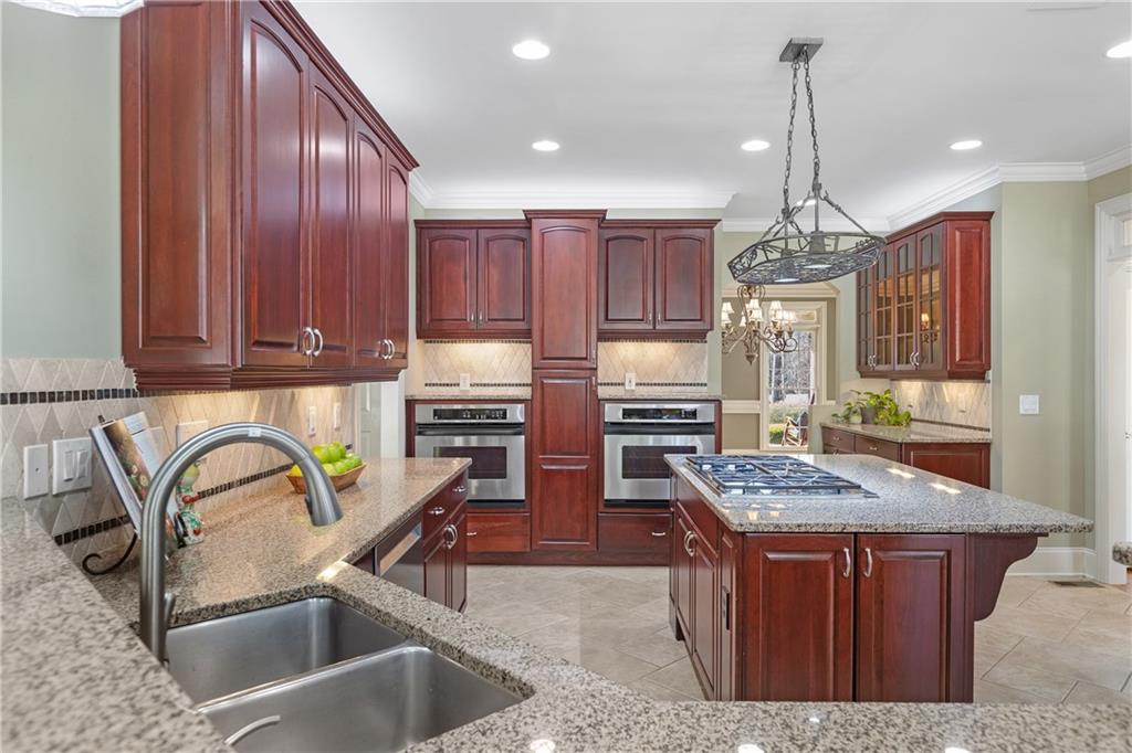 5300 Hill Road Acworth, GA 30101 - Photo 25 of 100 a kitchen with stainless steel appliances granite countertop a sink a stove and a wooden cabinets