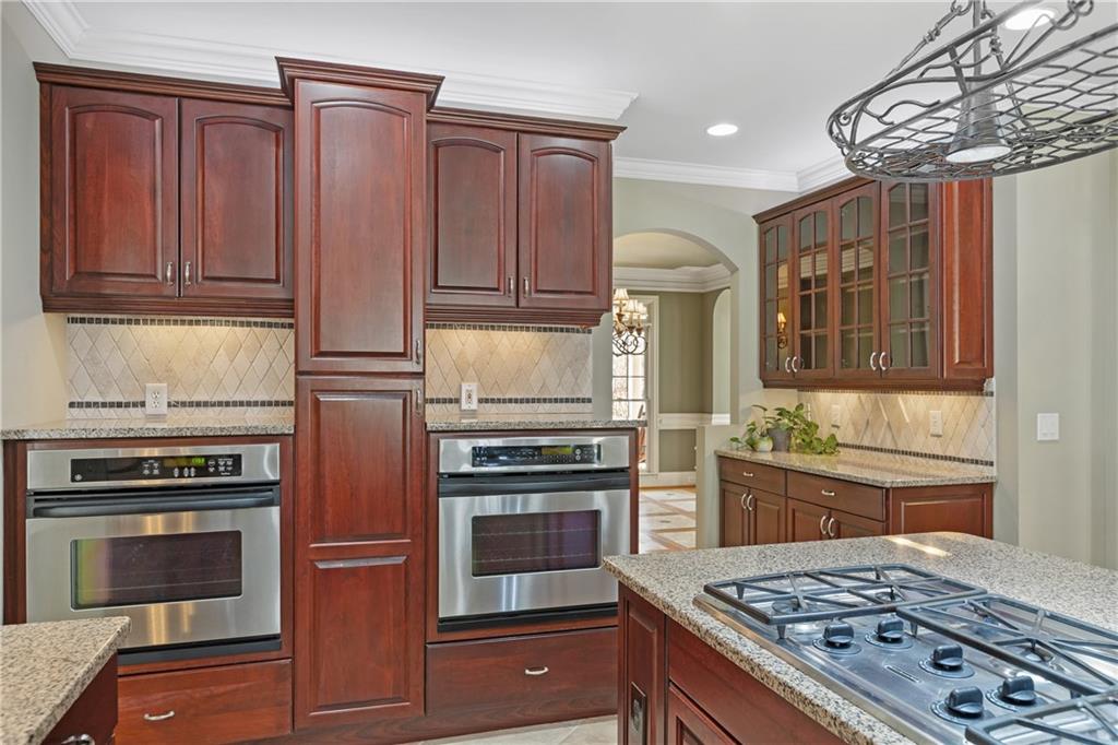 5300 Hill Road Acworth, GA 30101 - Photo 27 of 100 a kitchen with wooden cabinets and stainless steel appliances