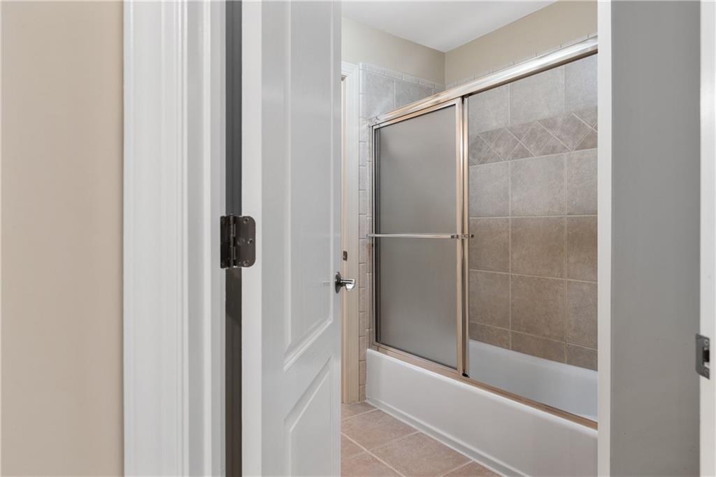 5300 Hill Road Acworth, GA 30101 - Photo 57 of 100 a bathroom with a glass shower door
