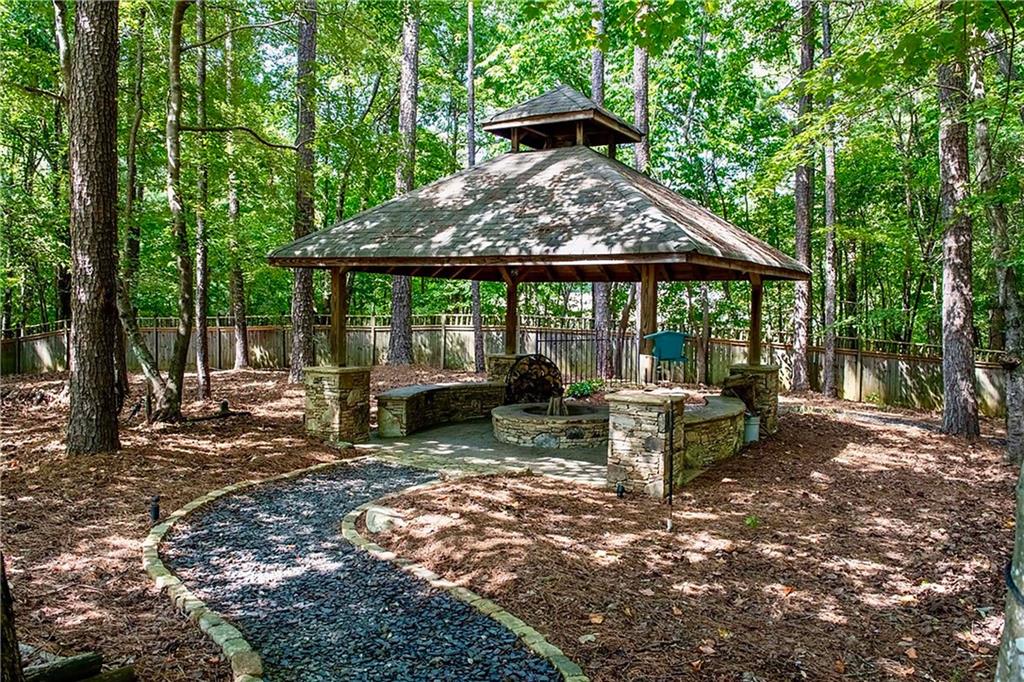 5300 Hill Road Acworth, GA 30101 - Photo 93 of 100 a view of a patio with a table chairs and a yard