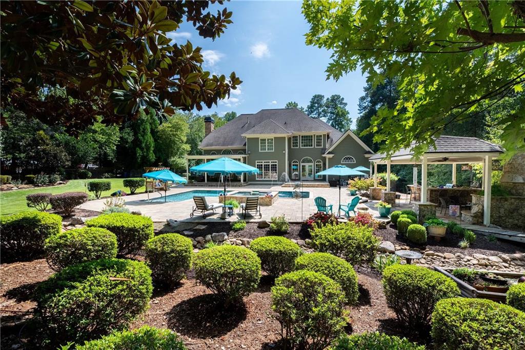5300 Hill Road Acworth, GA 30101 - Photo 100 of 100 a view of a swimming pool with lawn chairs under an umbrella