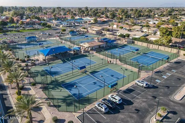 an aerial view of a house with a yard and lake view