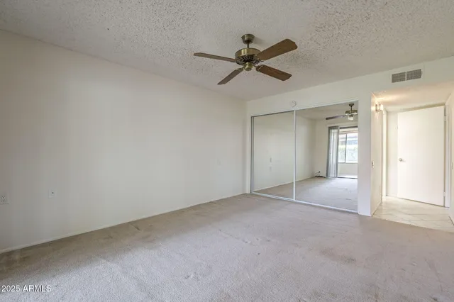 a view of a room with a ceiling fan