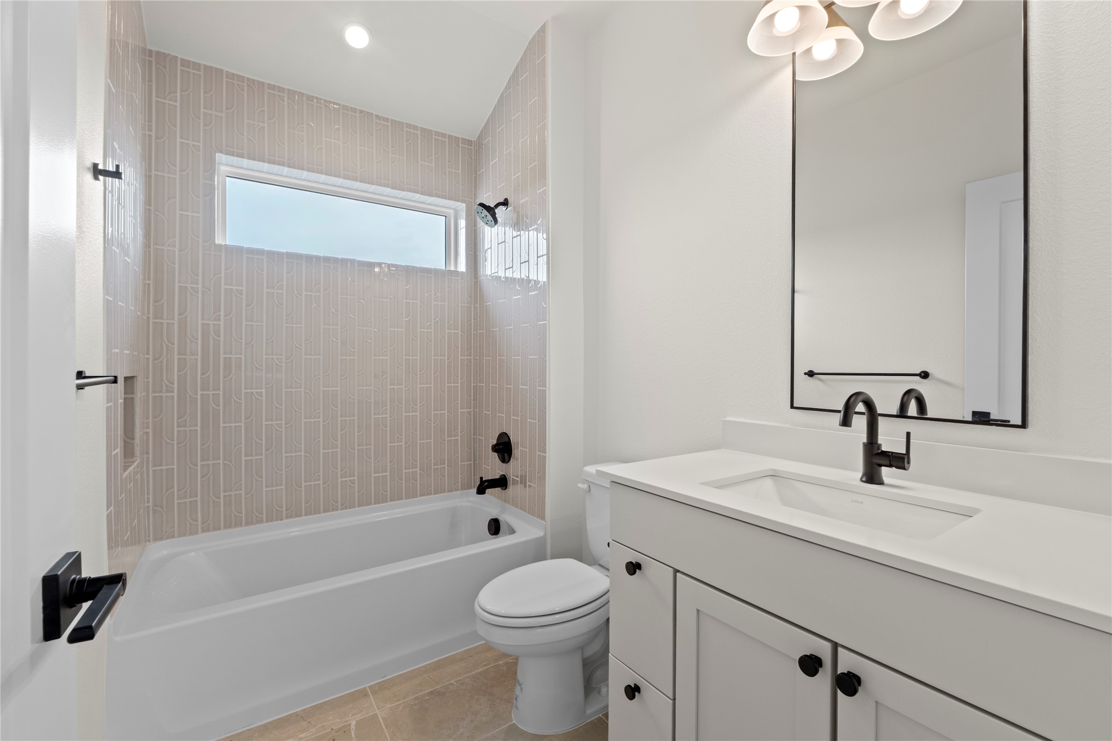 1406 Mason Avenue Austin, TX 78721 - Photo 11 of 36 MODEL HOME - REPRESENTATIVE PHOTO: Bathroom featuring a white vanity with integrated sink, matte black fixtures, rectangular mirror, and a tub-shower combination with vertical tile surround and horizontal window