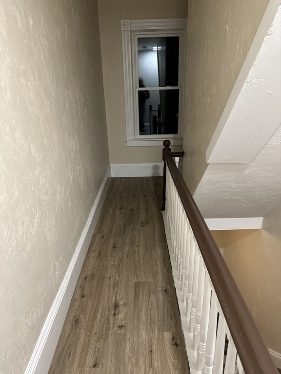 71 Flagg Street, Unit 2 Clinton, MA 01510 - Photo 12 of 13 a view of a hallway with wooden floor and staircase