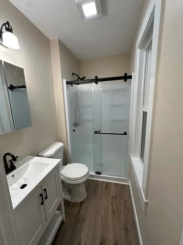 a bathroom with a sink toilet and shower