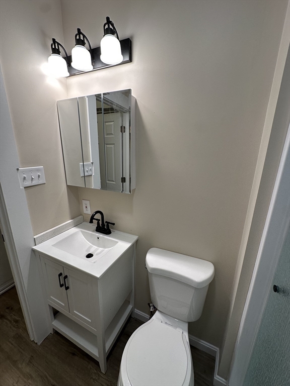 71 Flagg Street, Unit 2 Clinton, MA 01510 - Photo 5 of 13 a bathroom with a toilet sink and mirror