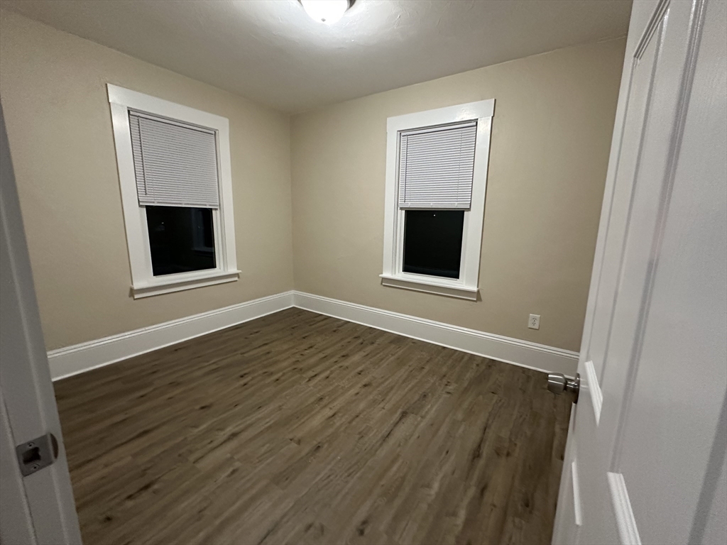 71 Flagg Street, Unit 2 Clinton, MA 01510 - Photo 7 of 13 a view of an empty room with wooden floor and a window