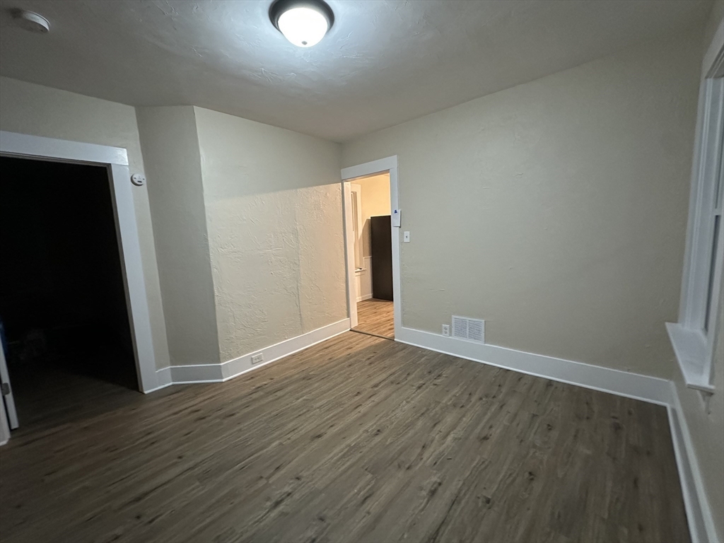 71 Flagg Street, Unit 2 Clinton, MA 01510 - Photo 8 of 13 an empty room with wooden floor and closet