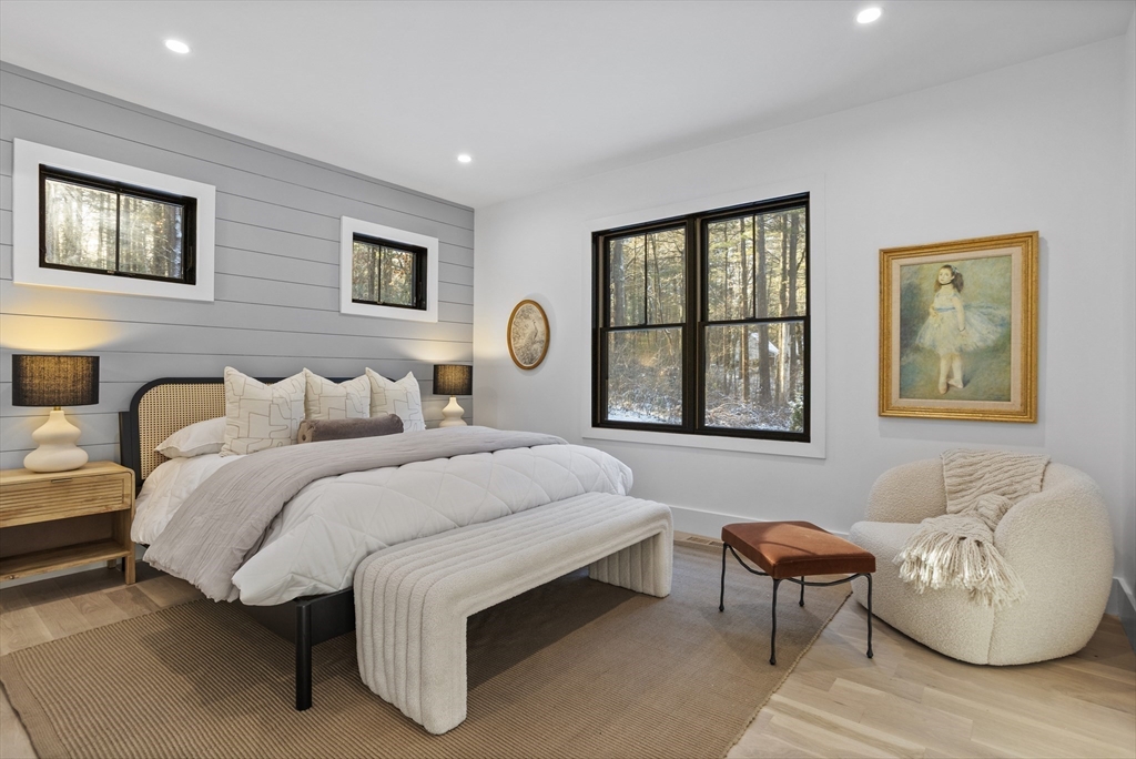 236 Fairhaven Road Concord, MA 01742 - Photo 15 of 35 a spacious bedroom with a bed and a couch
