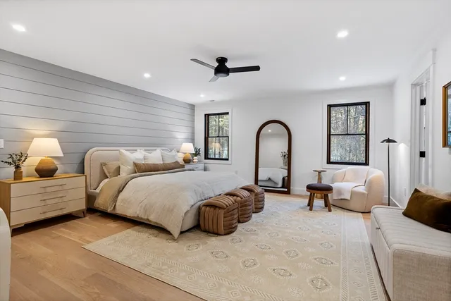 a spacious bedroom with bed and a large window