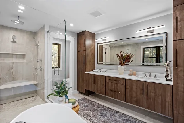 a bathroom with a double vanity sink mirror and shower