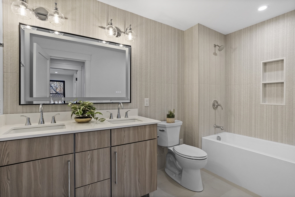 236 Fairhaven Road Concord, MA 01742 - Photo 23 of 35 a bathroom with a toilet a sink a tub and mirror