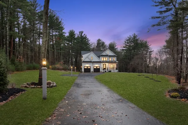 a view of a street with a house and a yard
