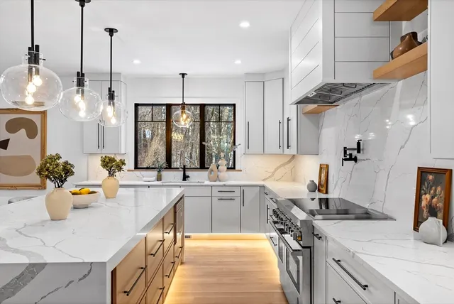 a kitchen with a sink a stove and chairs