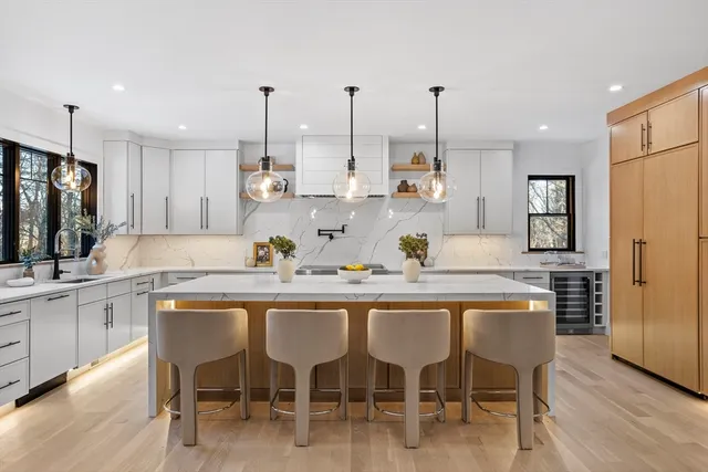 a kitchen with granite countertop cabinets table and chairs