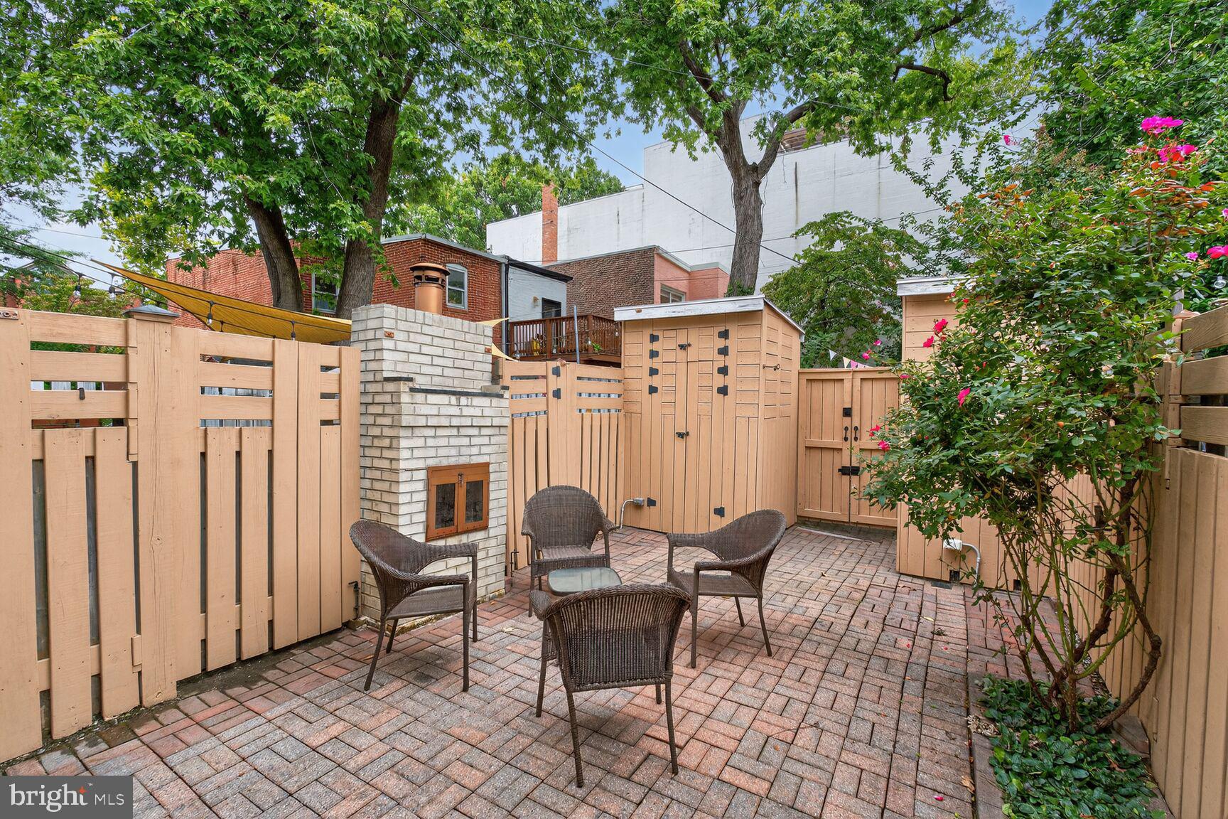 1410 C Street Southeast Washington, DC 20003 - Photo 14 of 19 Lovely rear patio with outdoor fireplace and shed