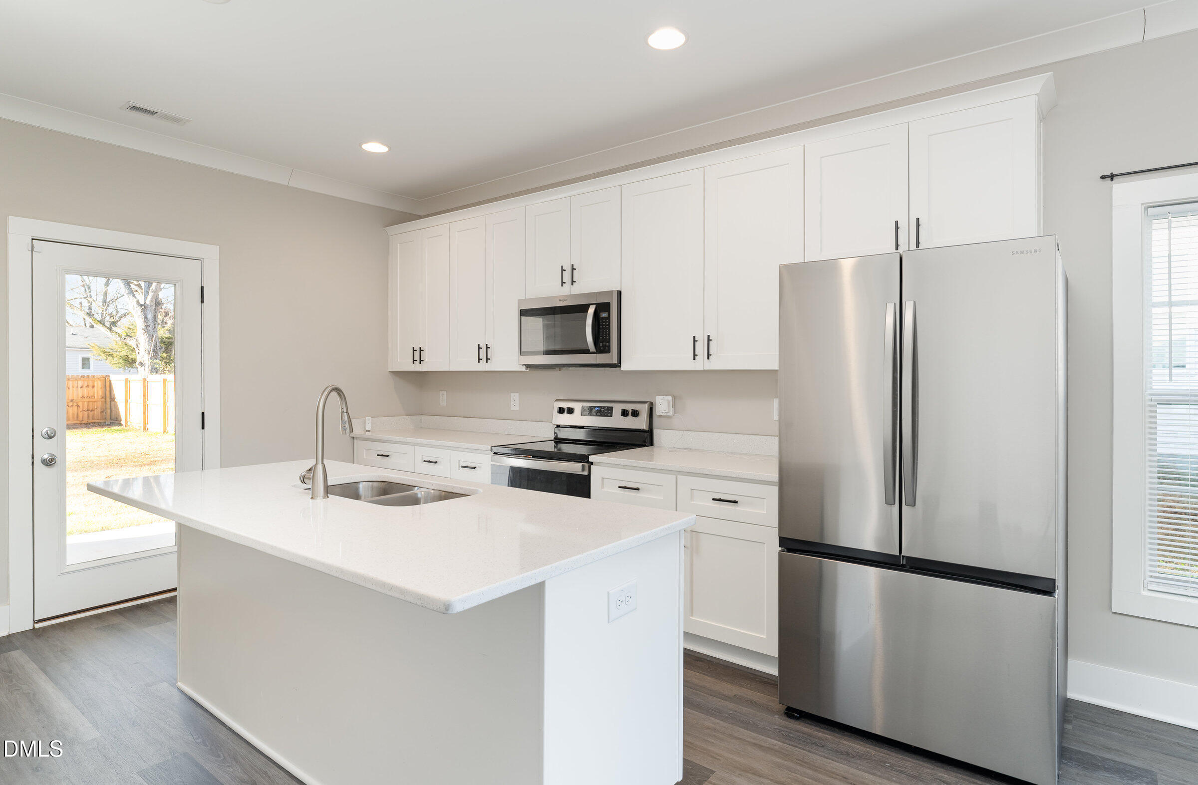 903 West Anderson Street, Unit 1/2 Selma, NC 27576 - Photo 12 of 36 a kitchen with stainless steel appliances a refrigerator stove microwave and sink