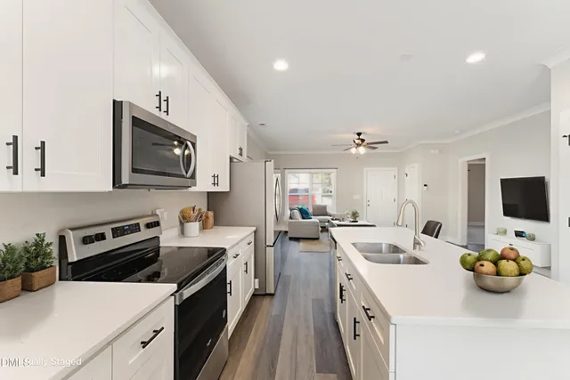 a bathroom with a double vanity sink toilet mirror and shower