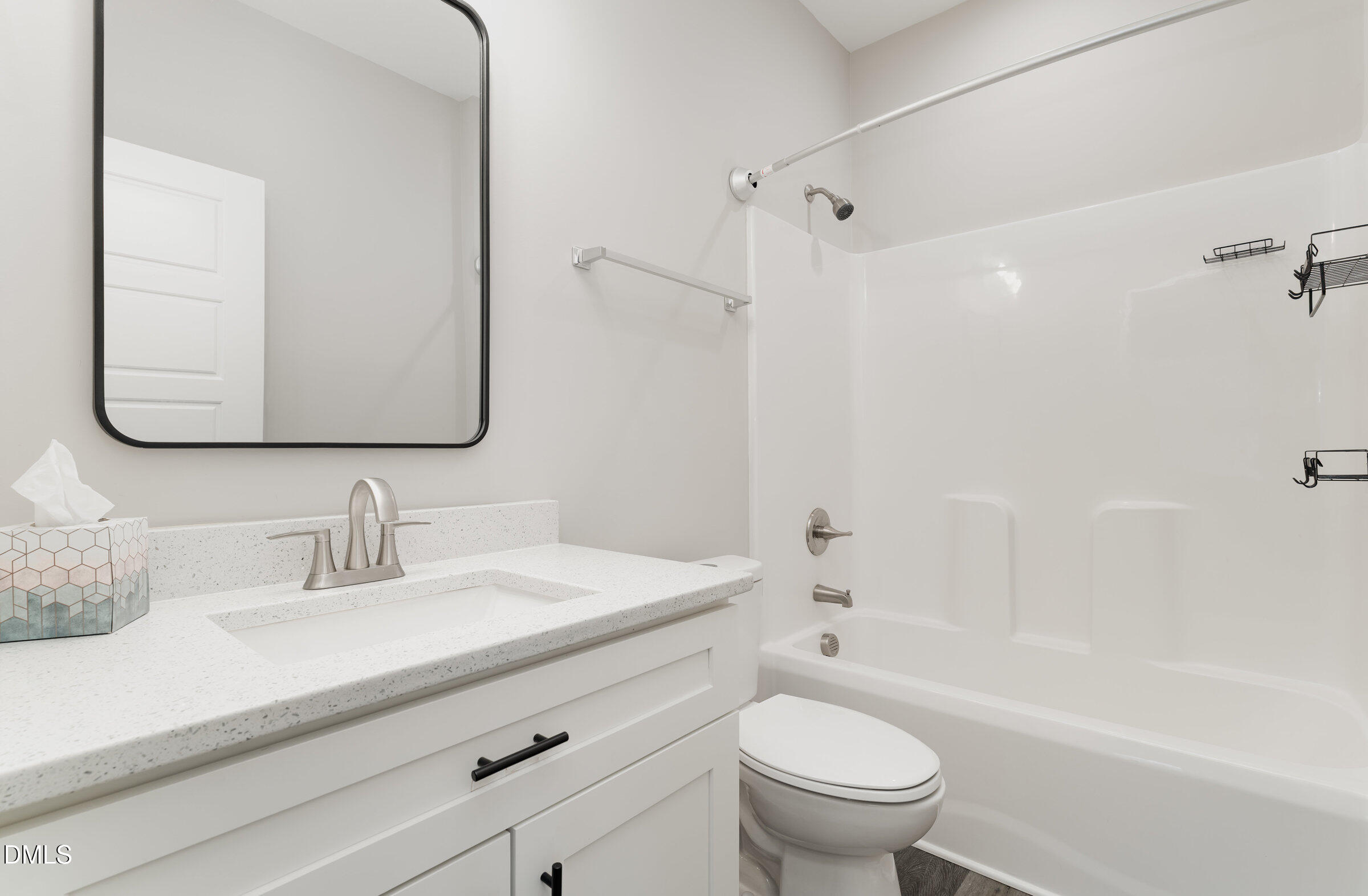 903 West Anderson Street, Unit 1/2 Selma, NC 27576 - Photo 28 of 36 a bathroom with a sink a toilet and a mirror