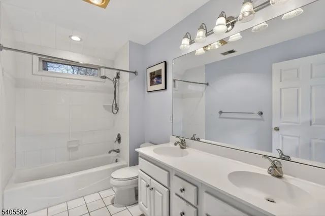 a bathroom with a tub a sink and a mirror