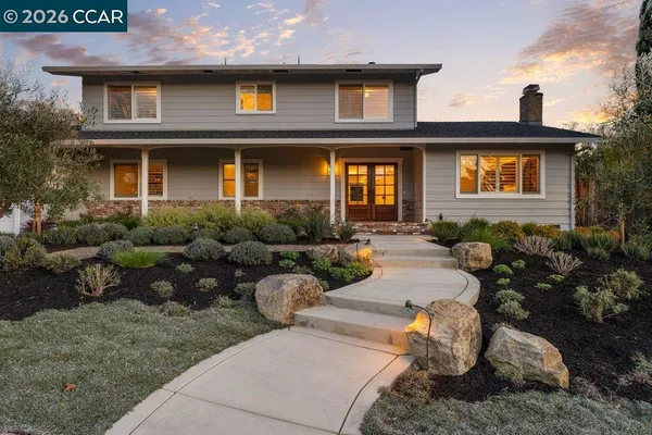 a kitchen with stainless steel appliances kitchen island granite countertop a table and chairs in it