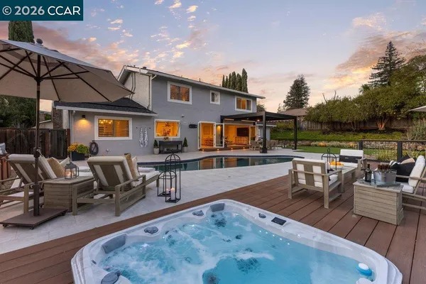 a view of a backyard with sitting area
